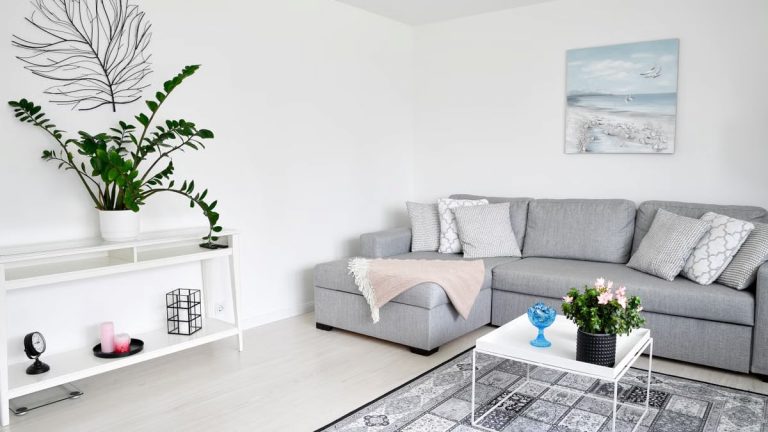 Stylish Scandinavian living room in Espoo, Finland, featuring a grey sofa, houseplants, and minimalist decor.